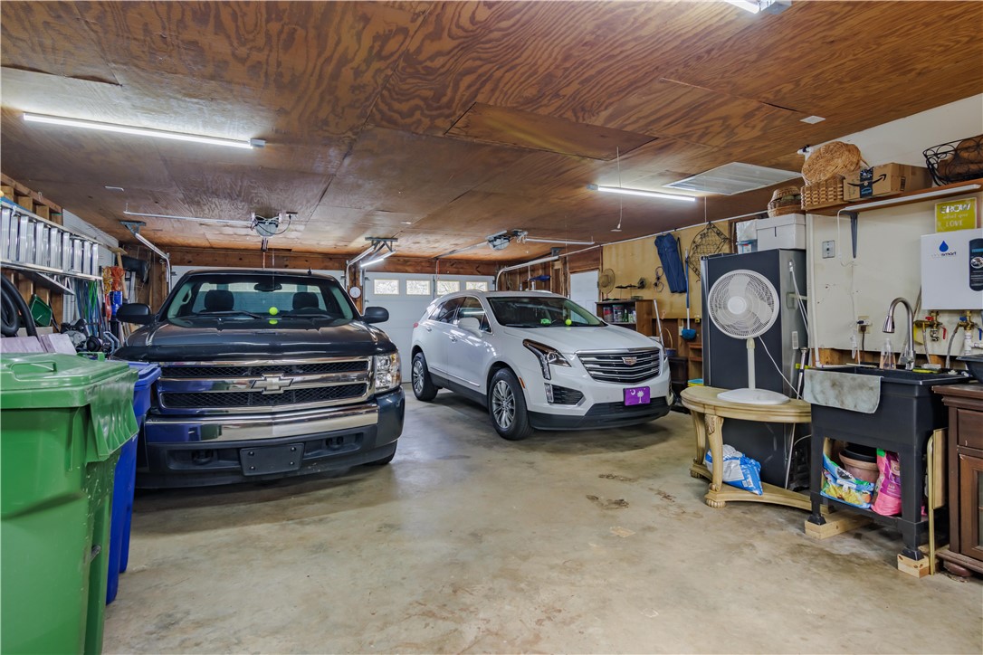 305 Farmdale Road Hodges, SC 29653 - Photo 38 of 48 This spacious garage offers ample room for vehicles and practical storage solutions.