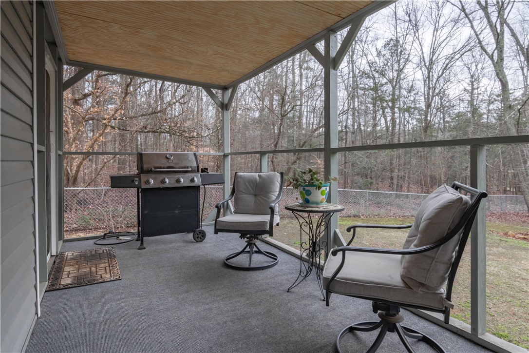 305 Farmdale Road Hodges, SC 29653 - Photo 39 of 48 This inviting covered porch provides a serene outdoor retreat, perfect for relaxation or entertaining.