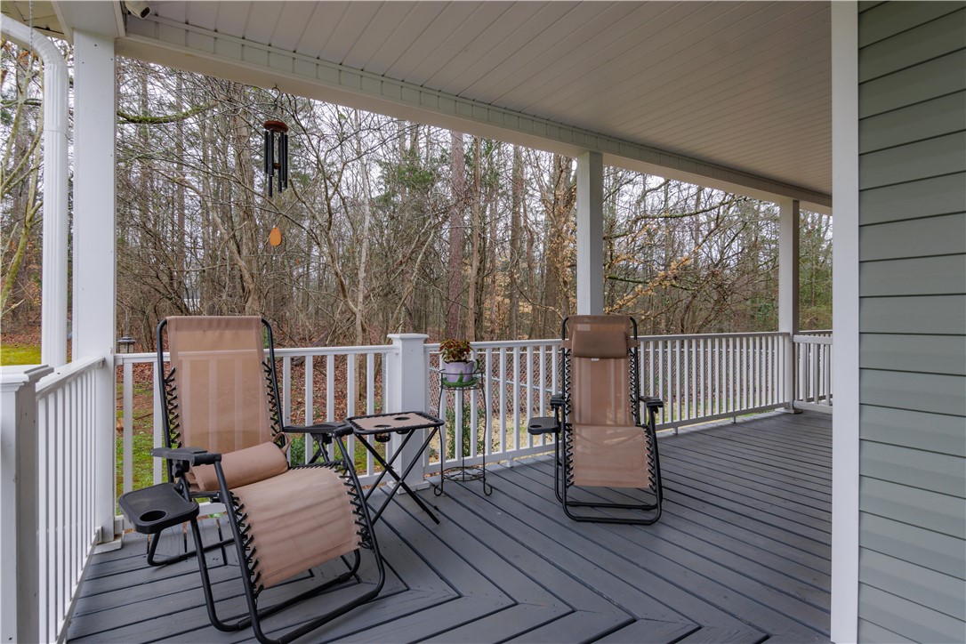 305 Farmdale Road Hodges, SC 29653 - Photo 41 of 48 This inviting covered porch provides a serene outdoor retreat, perfect for enjoying peaceful moments.
