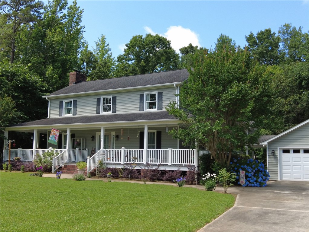 305 Farmdale Road Hodges, SC 29653 - Photo 44 of 48 Spring Yard-This charming residence features a broad porch, perfect for outdoor enjoyment.