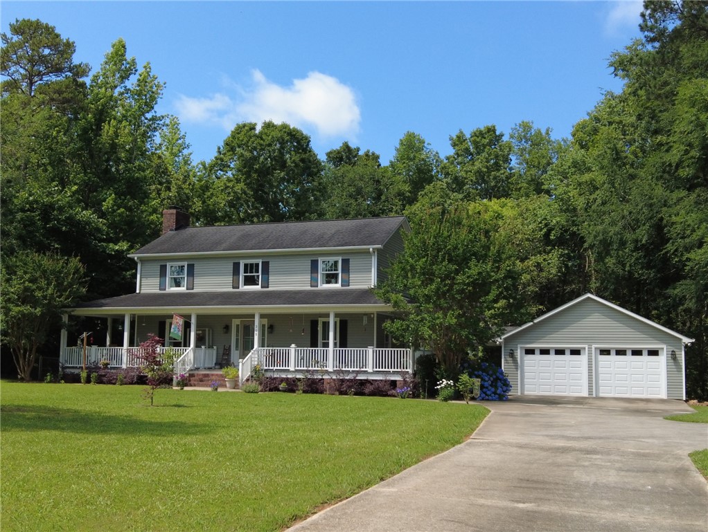 305 Farmdale Road Hodges, SC 29653 - Photo 45 of 48 Spring Yard- This classic two-story residence features a welcoming front porch, a spacious yard, and a detached garage.