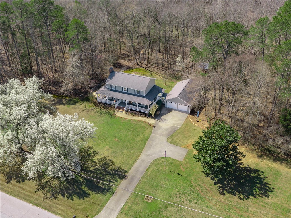 305 Farmdale Road Hodges, SC 29653 - Photo 7 of 48 An aerial view captures a serene home nestled amidst a lush, wooded landscape.