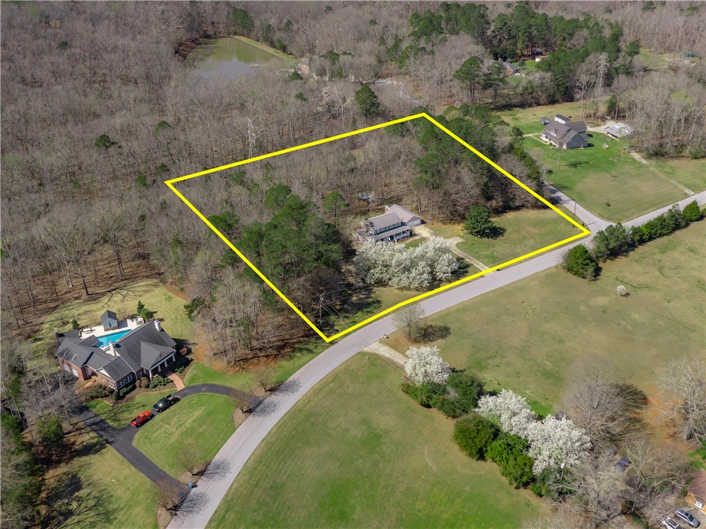 305 Farmdale Road Hodges, SC 29653 - Photo 9 of 48 This elevated view captures a serene residential landscape, featuring lush greenery and a tranquil pond.