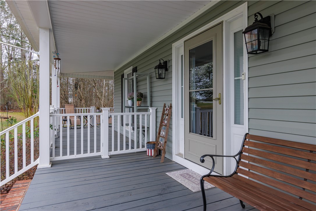 305 Farmdale Road Hodges, SC 29653 - Photo 10 of 48 Relax on this inviting covered porch, perfect for enjoying peaceful outdoor moments.
