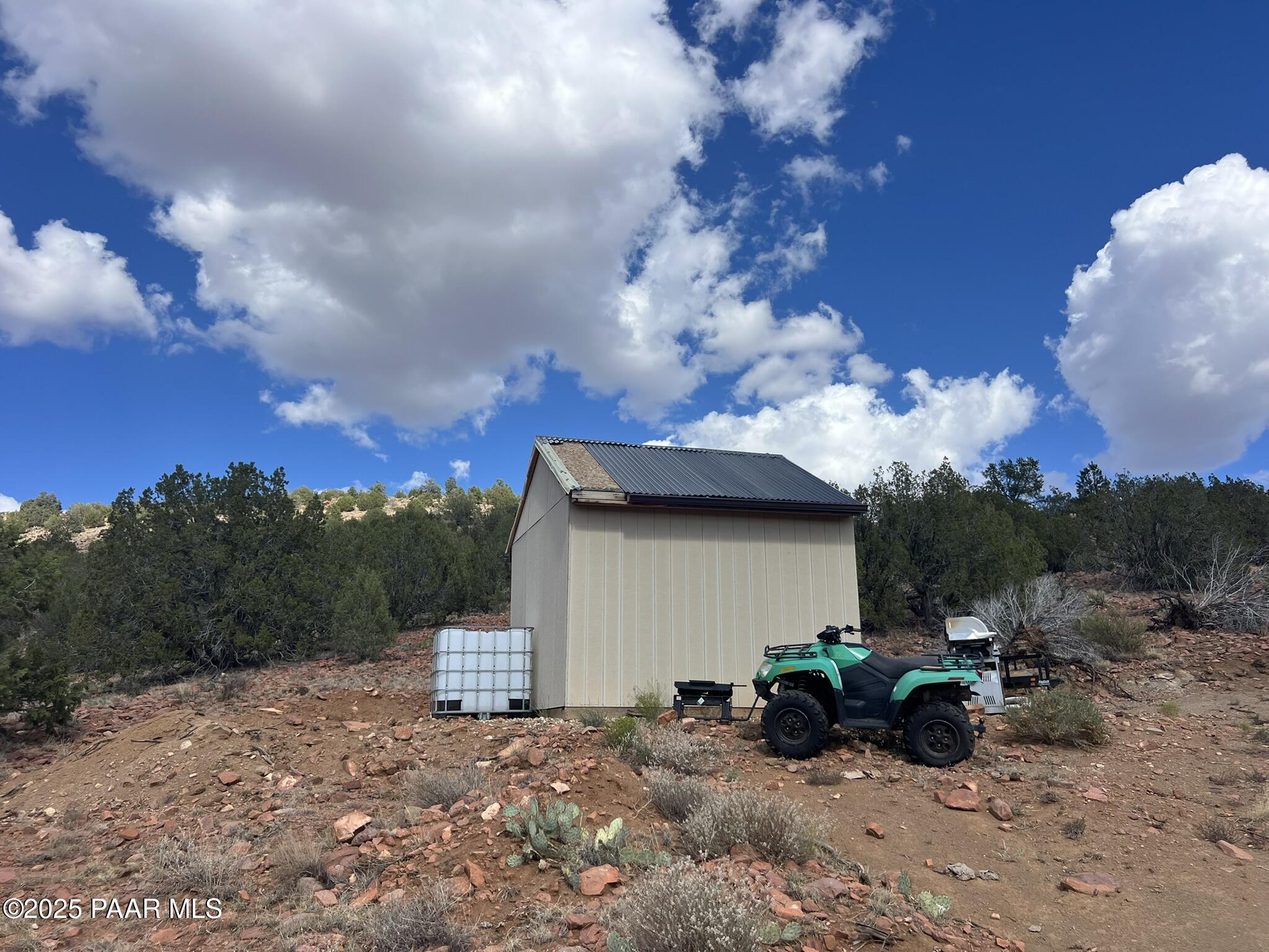 296 Quartz Hill Road Ash Fork, AZ 86320 - Photo 7 of 13 a view of a house with a bench in a yard