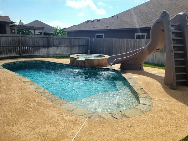 a view of a backyard with sitting area