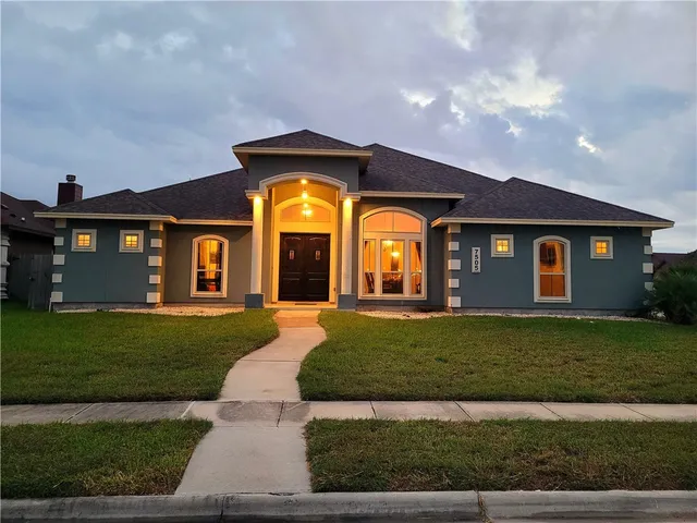 a front view of a house with a yard
