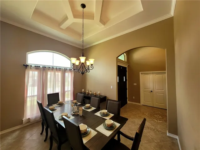 a dining room with a table and chairs