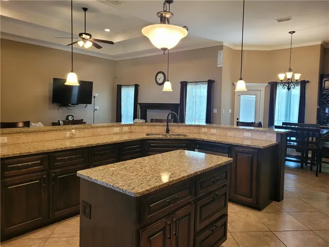 a kitchen with a counter a sink and a refrigerator