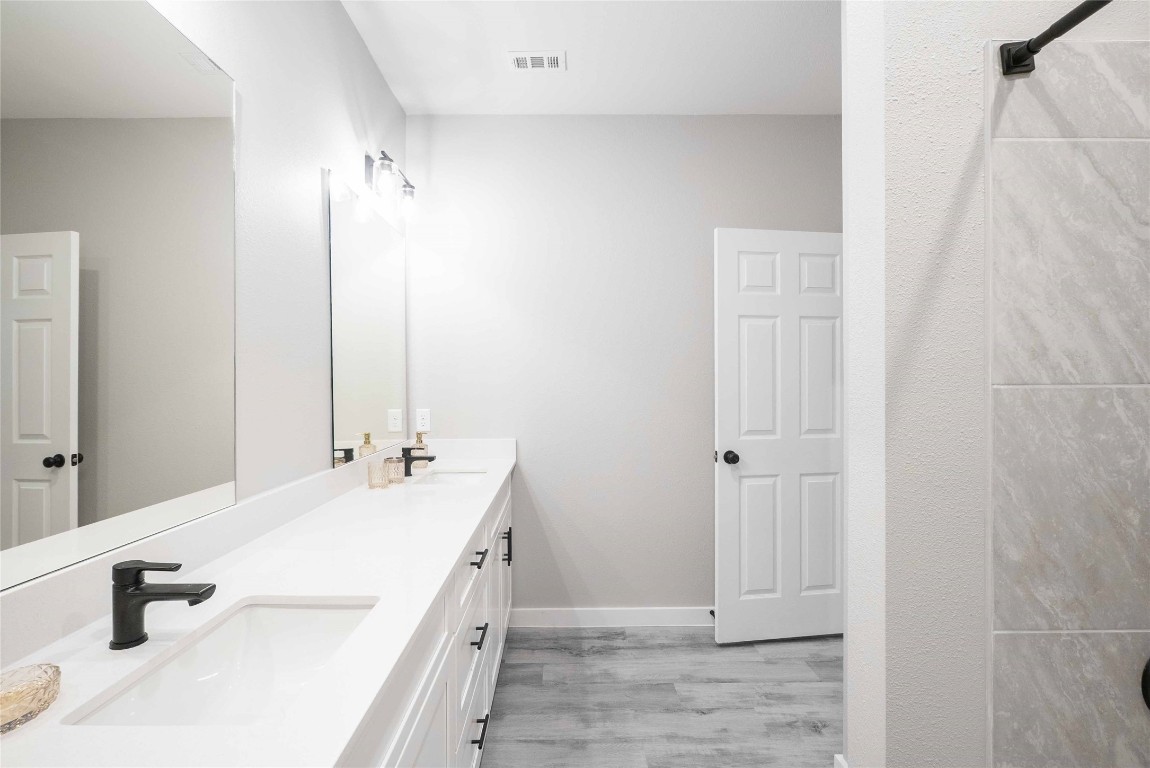 2101 Reinke Road, Unit 8109 Waller, TX 77484 - Photo 11 of 24 a bathroom with a double vanity sink and a mirror