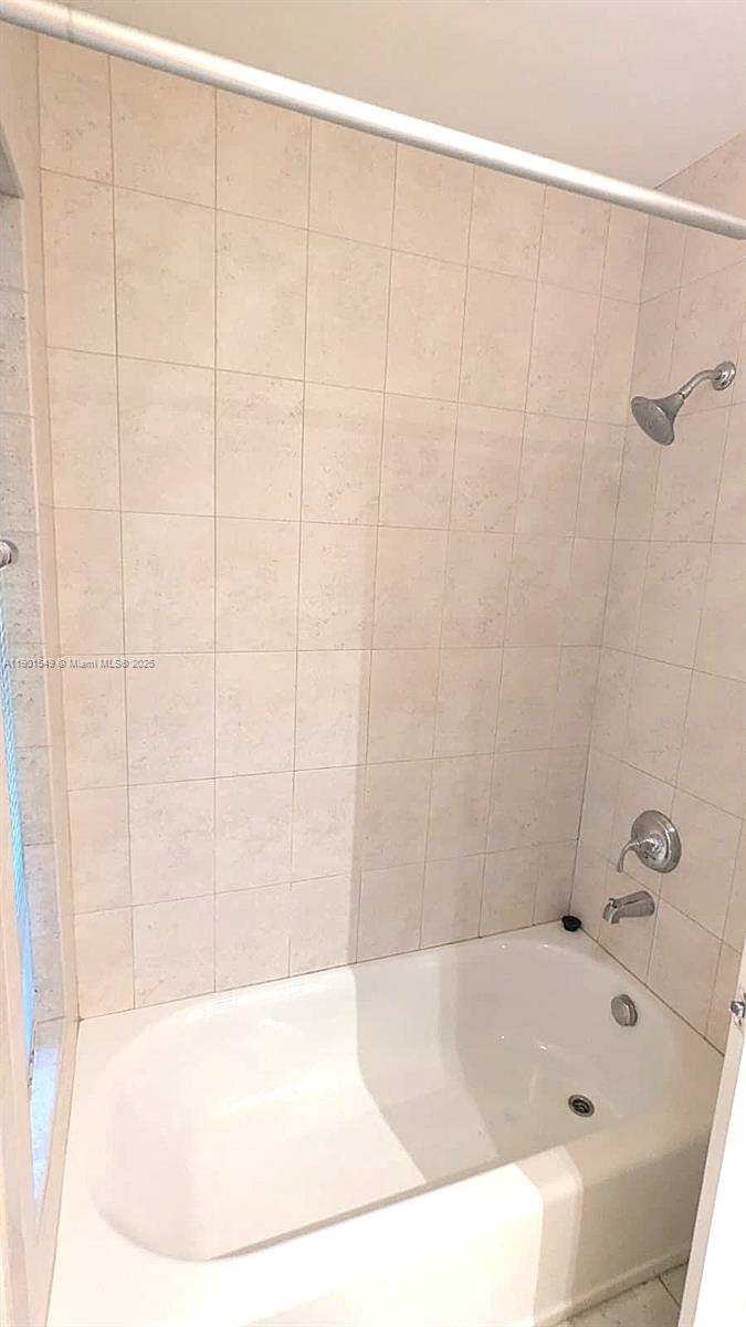 10140 Torchwood Avenue Plantation, FL 33324 - Photo 12 of 18 a bathroom with a white bath tub and a shower curtain