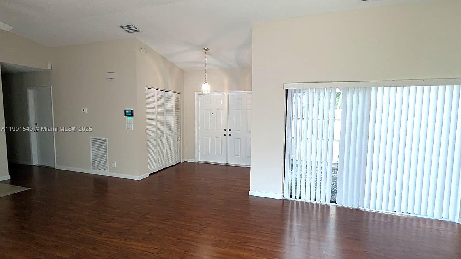 10140 Torchwood Avenue Plantation, FL 33324 - Photo 2 of 18 an empty room with wooden floor and a window