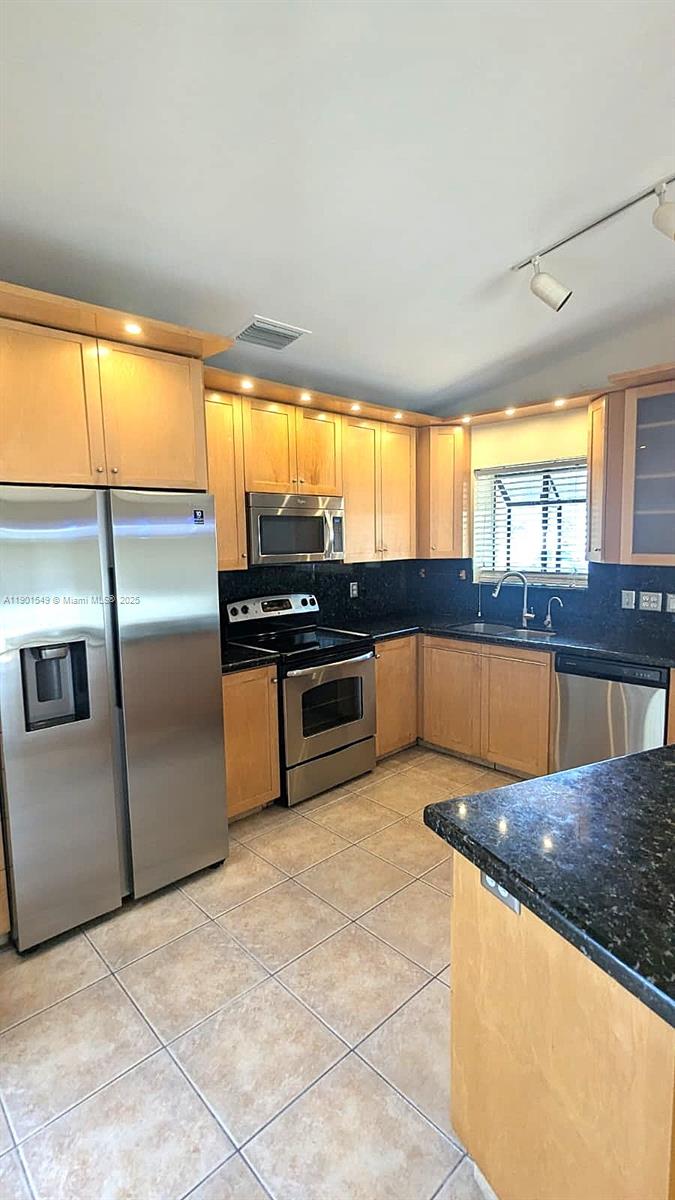 10140 Torchwood Avenue Plantation, FL 33324 - Photo 5 of 18 a kitchen with stainless steel appliances granite countertop a stove a sink and a refrigerator