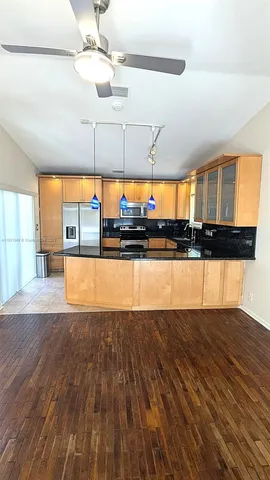 a view of a kitchen with kitchen island and a large window