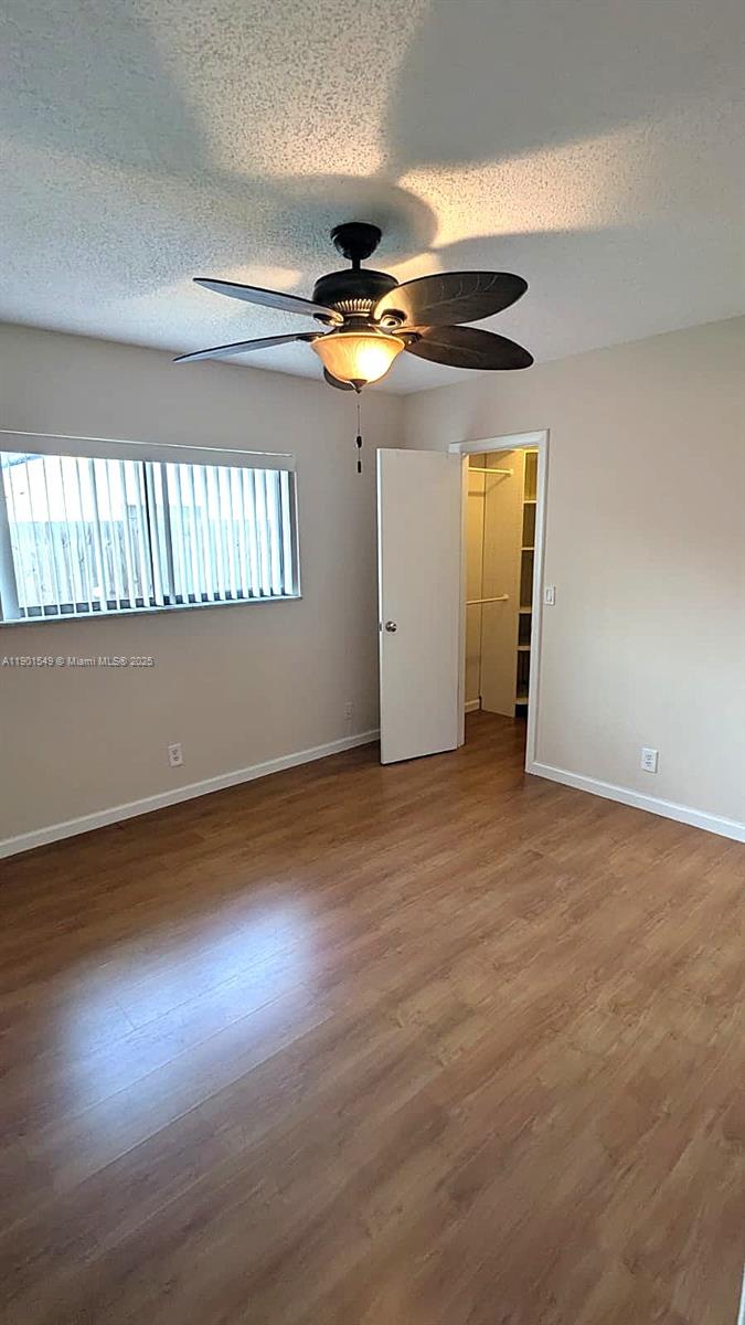 10140 Torchwood Avenue Plantation, FL 33324 - Photo 9 of 18 a view of an empty room with window and wooden floor