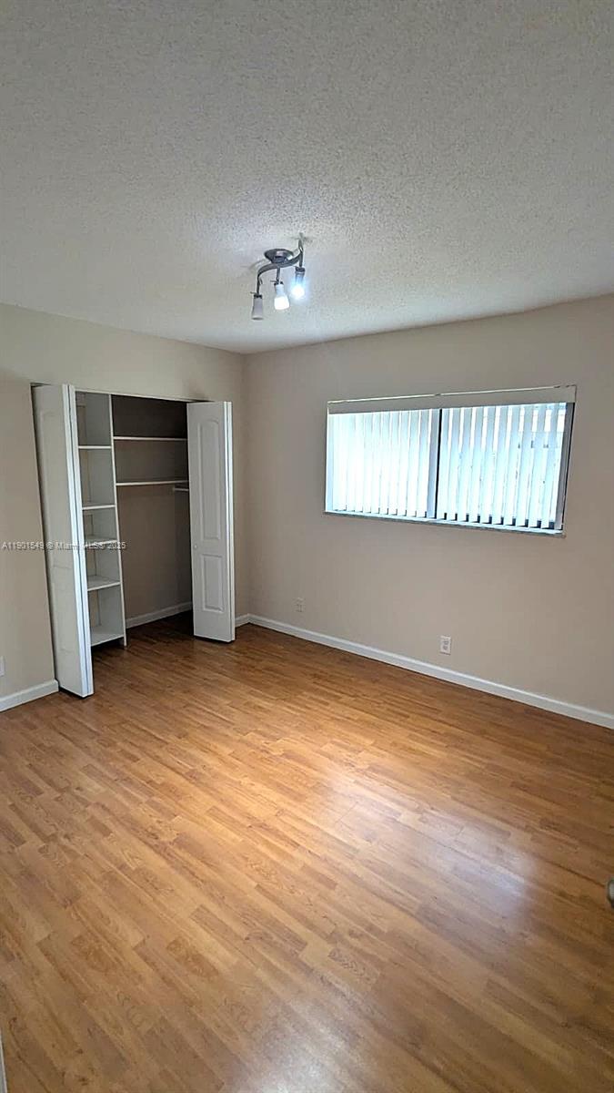 10140 Torchwood Avenue Plantation, FL 33324 - Photo 10 of 18 a view of empty room with wooden floor and fan