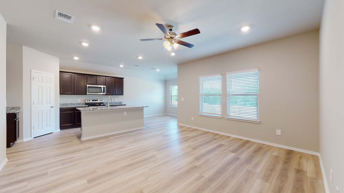 544 Hector Loop Georgetown, TX 78626 - Photo 8 of 22 An open concept design seamlessly connects the kitchen with a generously proportioned living space.