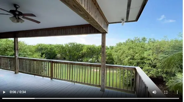 a view of balcony with floor to ceiling windows and wooden floor
