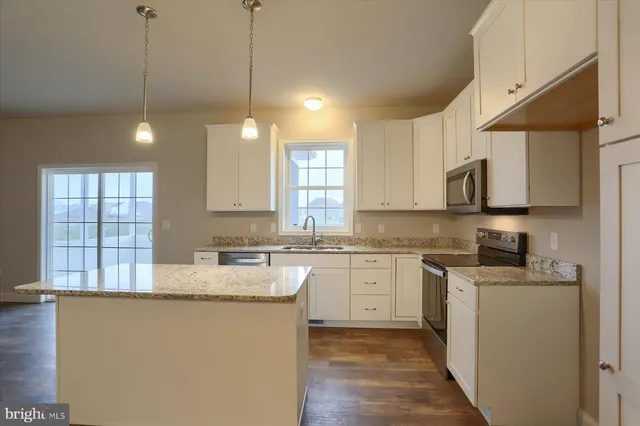 a view of an empty room with a window and fireplace