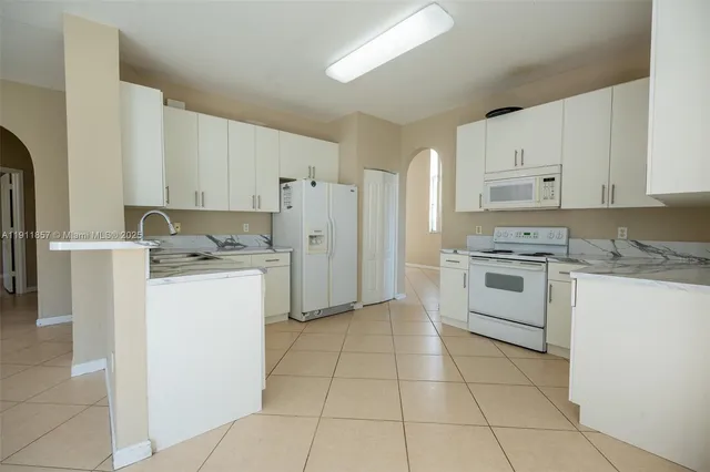 a kitchen with cabinets and white appliances