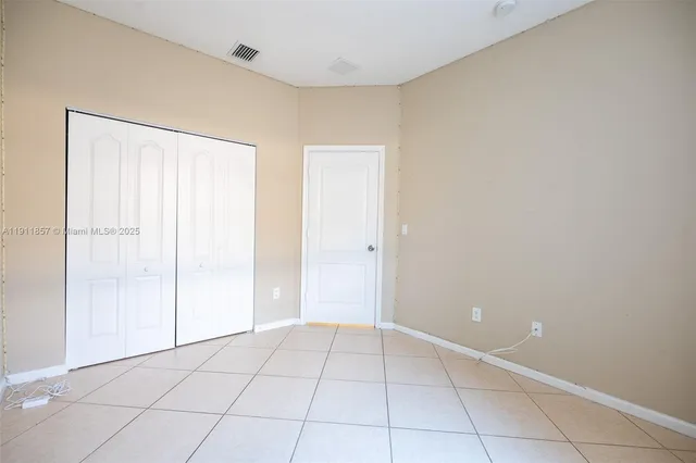 a view of an empty room with closet