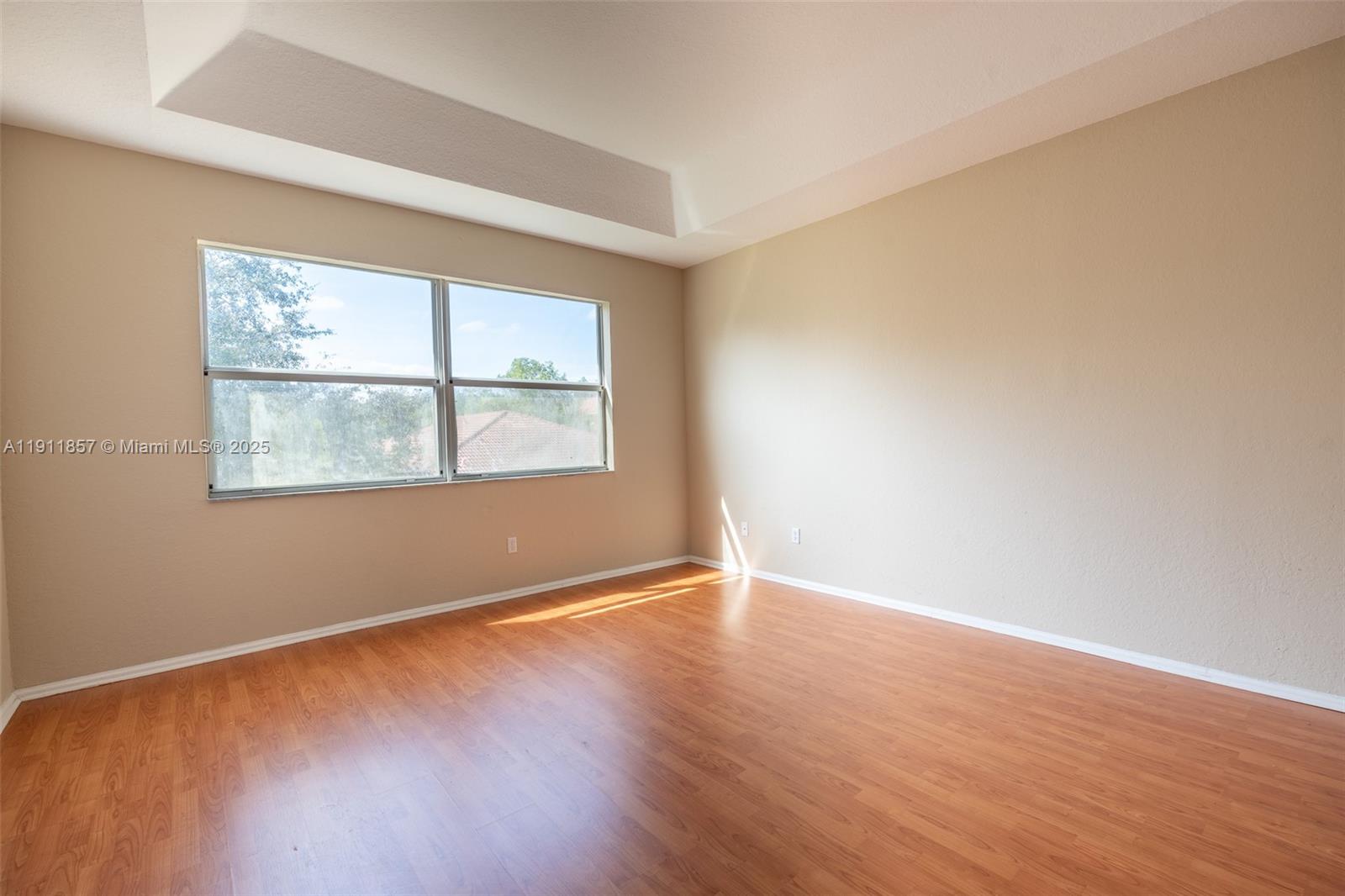 1770 Northeast 37th Place Homestead, FL 33033 - Photo 22 of 39 an empty room with wooden floor and windows
