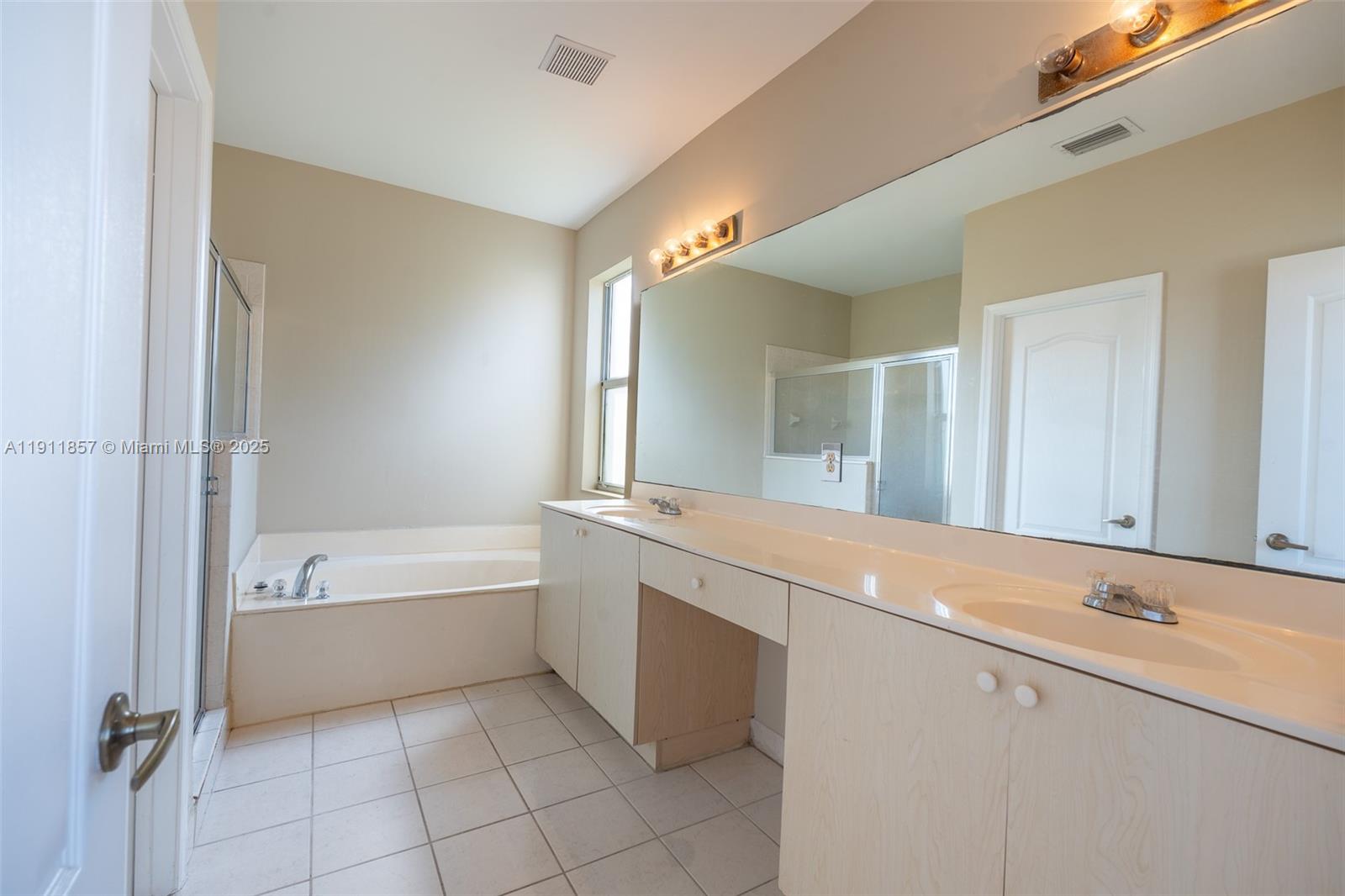1770 Northeast 37th Place Homestead, FL 33033 - Photo 25 of 39 a bathroom with a bathtub and a sink