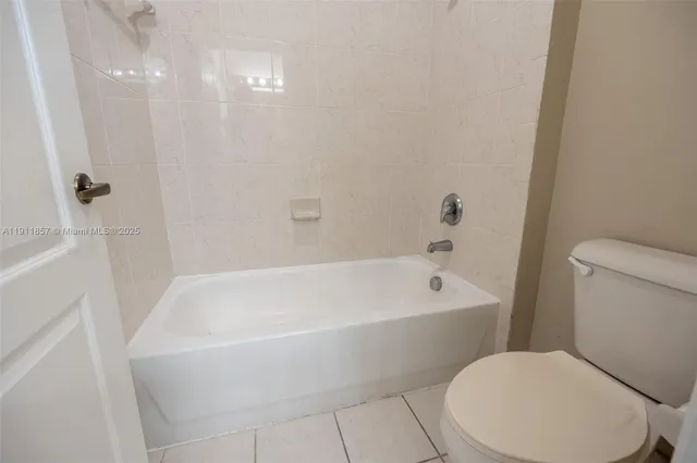a white bath tub sitting next to a white toilet and sink