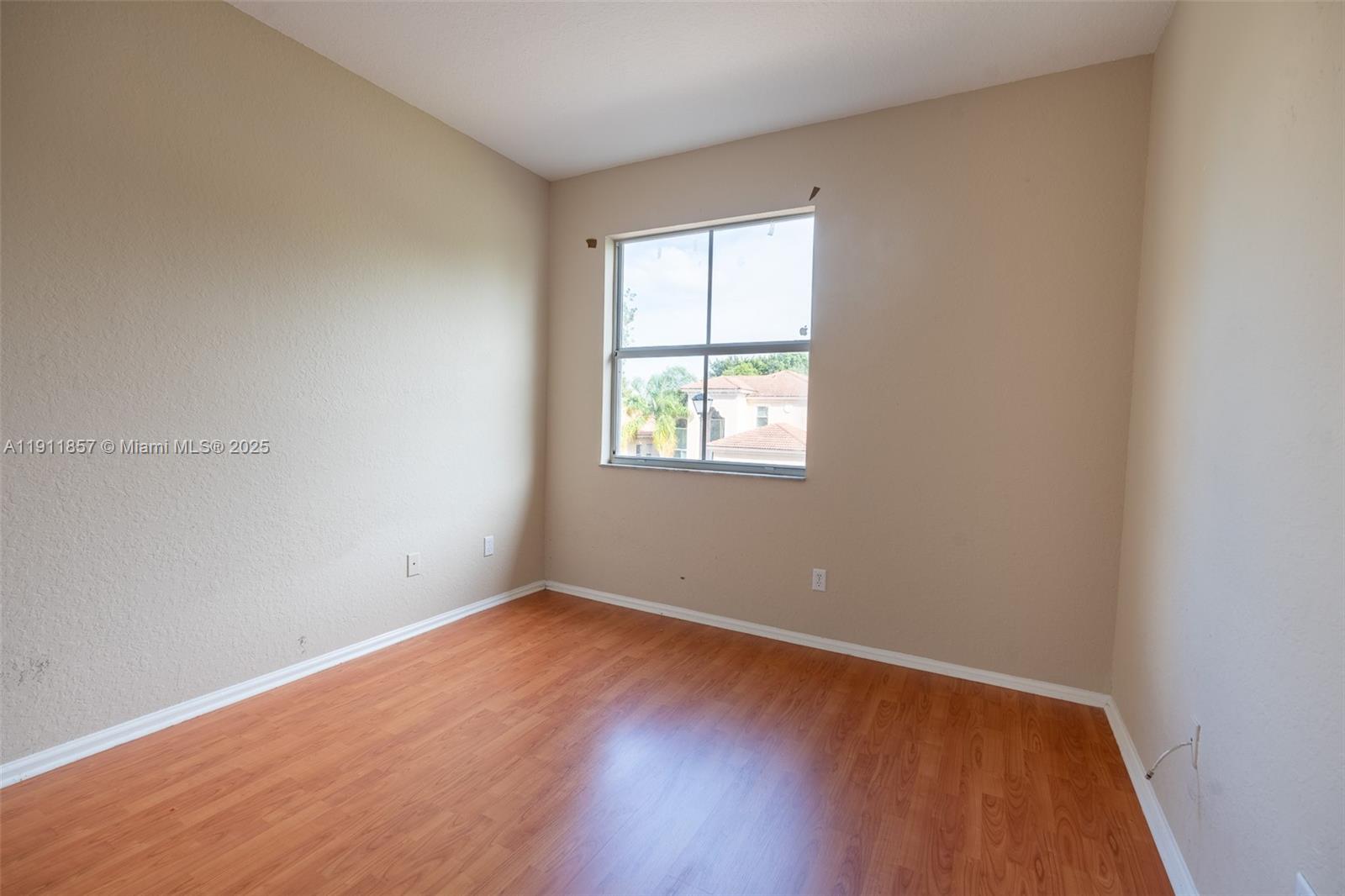1770 Northeast 37th Place Homestead, FL 33033 - Photo 36 of 39 an empty room with wooden floor and windows