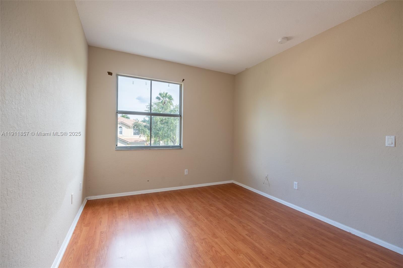 1770 Northeast 37th Place Homestead, FL 33033 - Photo 39 of 39 an empty room with wooden floor and windows