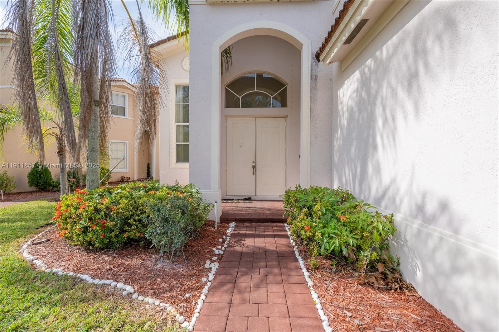 1770 Northeast 37th Place Homestead, FL 33033 - Photo 4 of 39 a front view of a house with garden