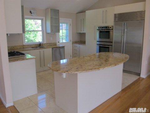 5 Elm Street Great Neck, NY 11021 - Photo 7 of 17 a kitchen with kitchen island a sink a stove a refrigerator and island