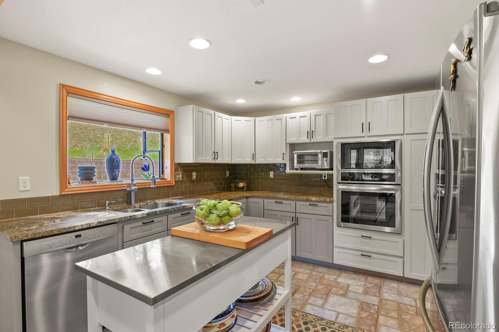 417 Witter Gulch Road Evergreen, CO 80439 - Photo 19 of 50 a kitchen with a stove a sink and a refrigerator