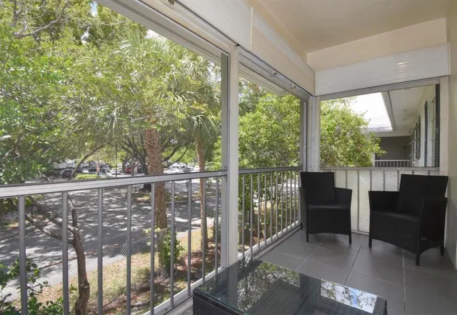 a view of a chair and table in the balcony