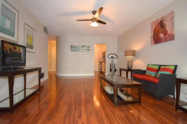 a living room with furniture a fireplace and wooden floor