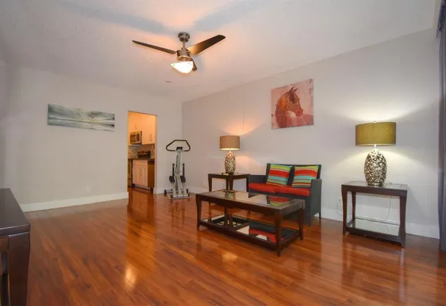 a living room with furniture and wooden floor