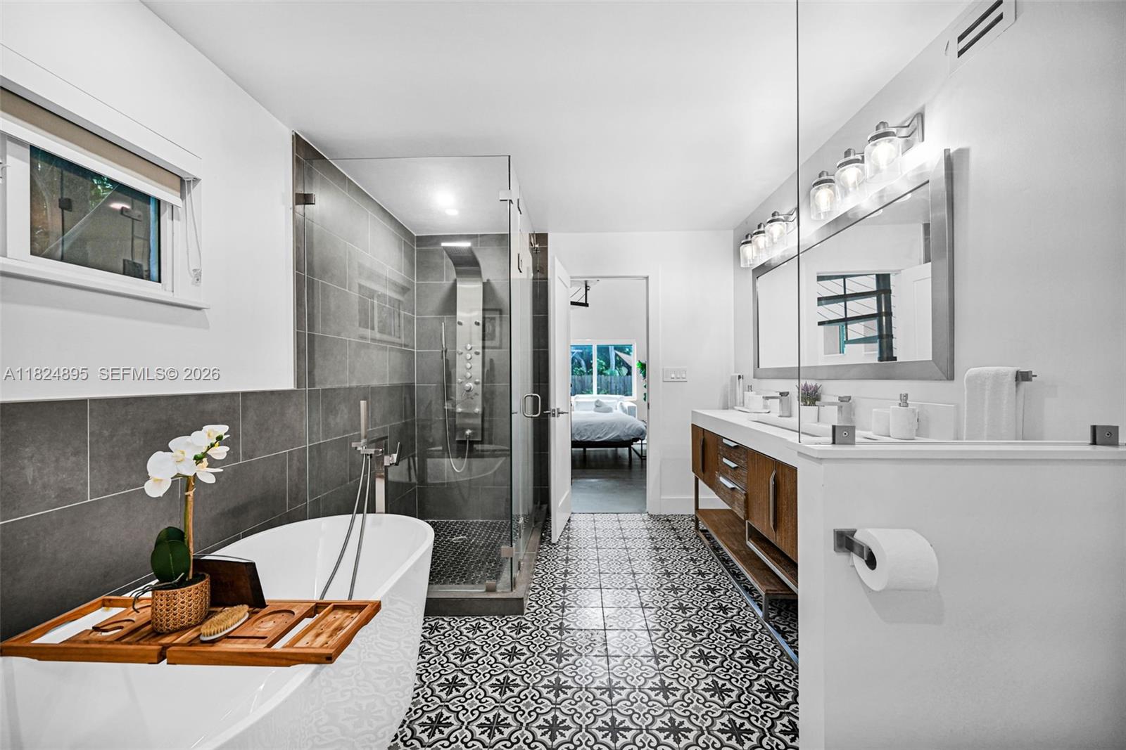 150 Northeast 50th Street, Unit A Miami, FL 33137 - Photo 13 of 100 a bathroom with a tub sink and mirror