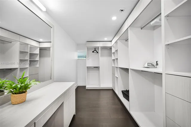 a bedroom with a bed and a ceiling fan