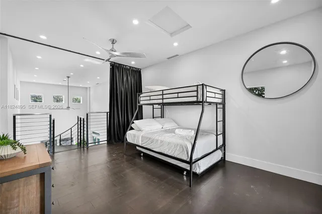 a living room with fireplace furniture and a large window