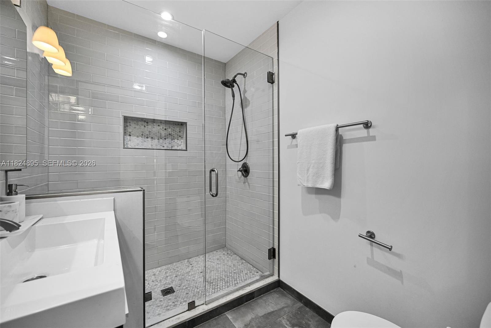 150 Northeast 50th Street, Unit A Miami, FL 33137 - Photo 37 of 100 a bathroom with a shower and a sink