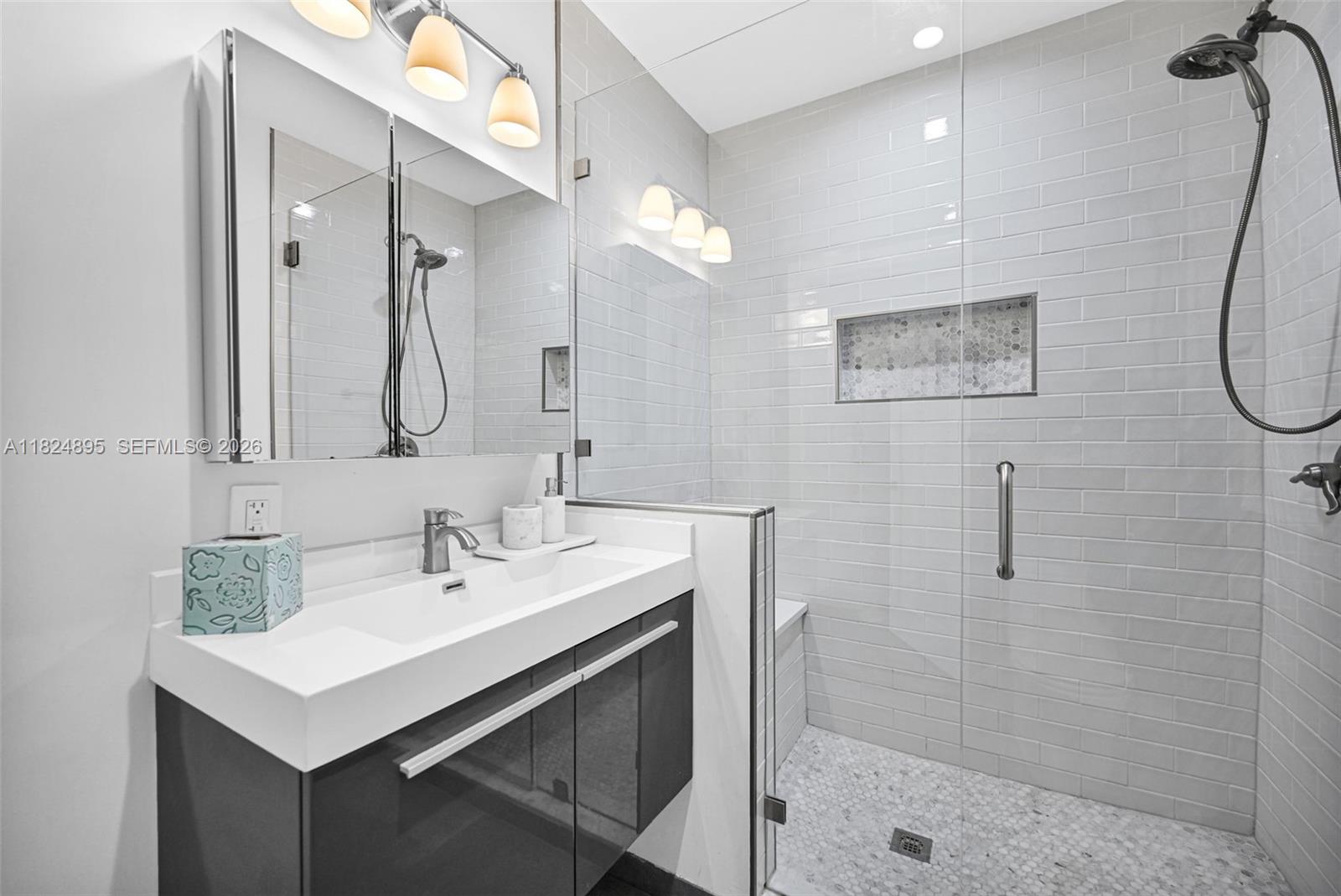 150 Northeast 50th Street, Unit A Miami, FL 33137 - Photo 38 of 100 a bathroom with a sink mirror and a shower