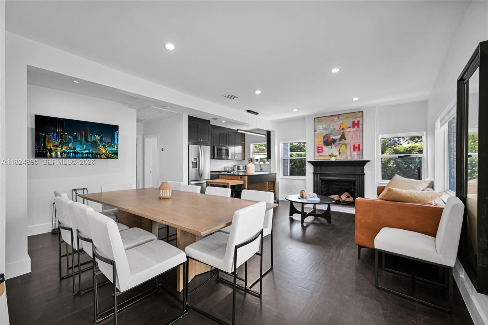 150 Northeast 50th Street, Unit A Miami, FL 33137 - Photo 41 of 100 a living room with furniture a flat screen tv and a fireplace