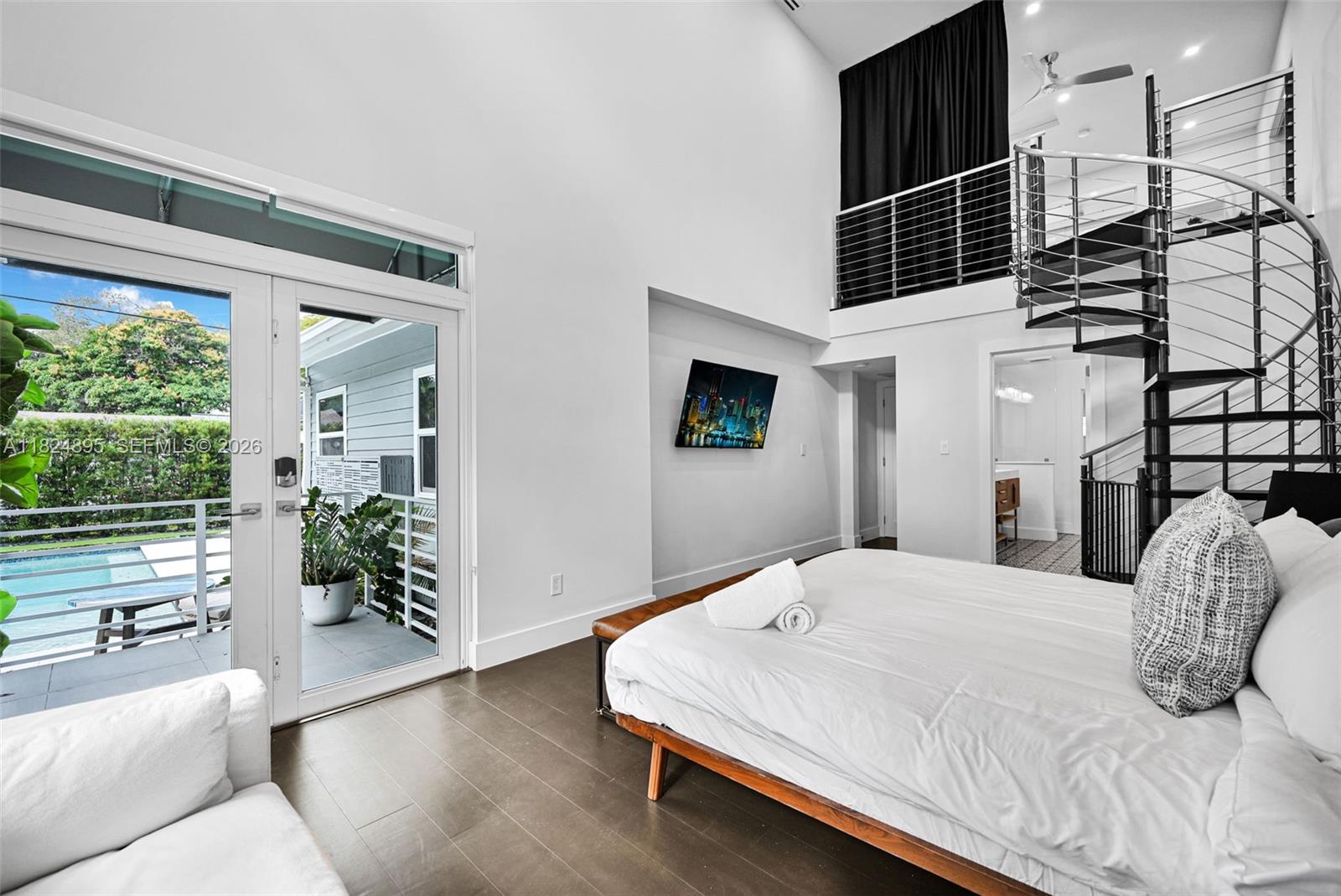 150 Northeast 50th Street, Unit A Miami, FL 33137 - Photo 9 of 100 a bedroom with a bed and a potted plant