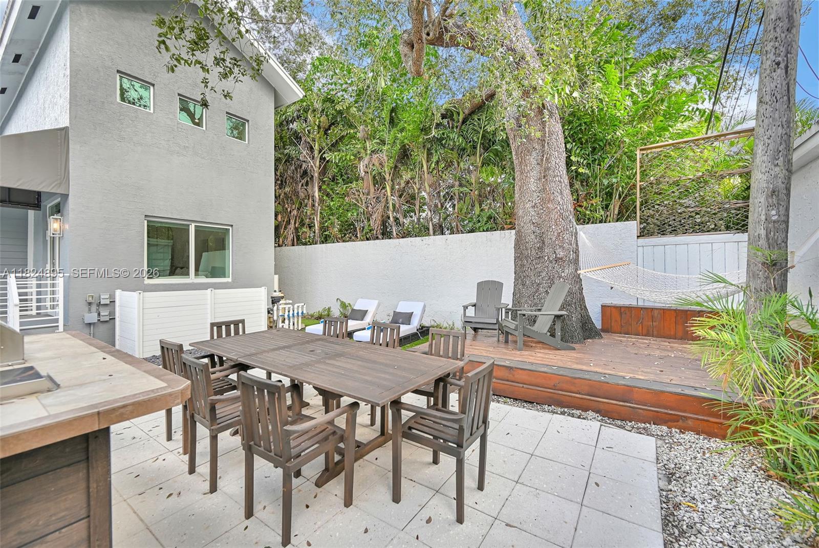 150 Northeast 50th Street, Unit A Miami, FL 33137 - Photo 95 of 100 a view of an outside dining space with furniture