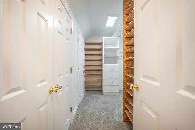 a view of a hallway with wooden floor and entryway
