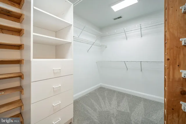 a view of a hallway with wooden floor and stairs