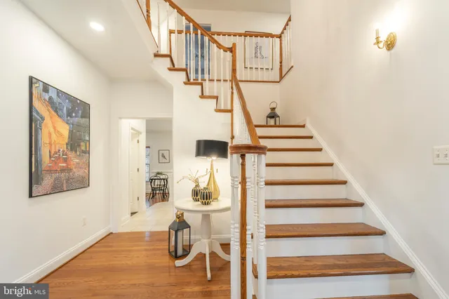 a view of entryway dining room and hall with wooden floor