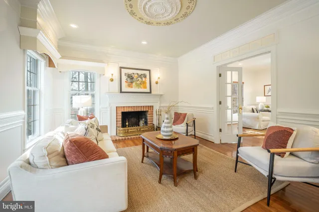 a dining room with wooden floor a glass table and chairs