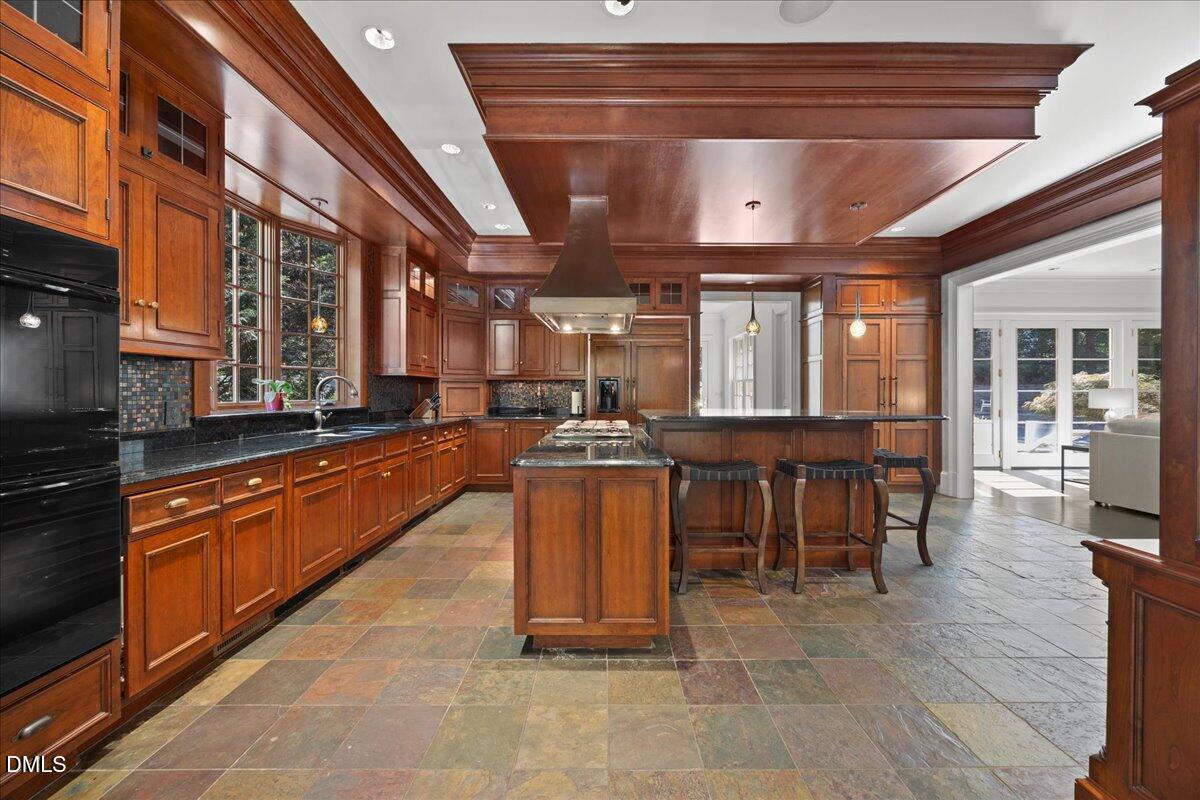 2525 Glenwood Avenue Raleigh, NC 27608 - Photo 8 of 39 a large kitchen with stainless steel appliances granite countertop a stove granite counter tops and a view of living room