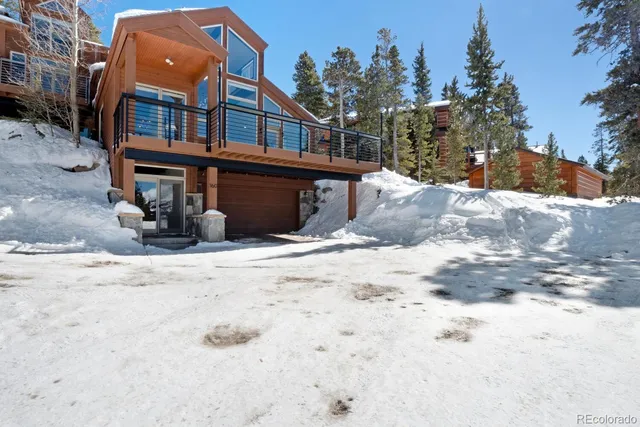 a view of a house with a snow in the background
